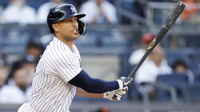 Giancarlo Stanton #27 of the New York Yankees hits a solo home run during the third inning against the San Francisco Giants at Yankee Stadium on April 01, 2023 in the Bronx borough of New York City. 
