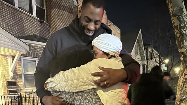 Timothy Turner hugs his children outside his home. 