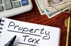 Property tax written in a notebook and calculator. 