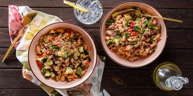 Chopped Greek salads with white beans plated for two, overhead shot