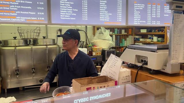 Min Kim stands behind the counter at the Starlite Deli. 