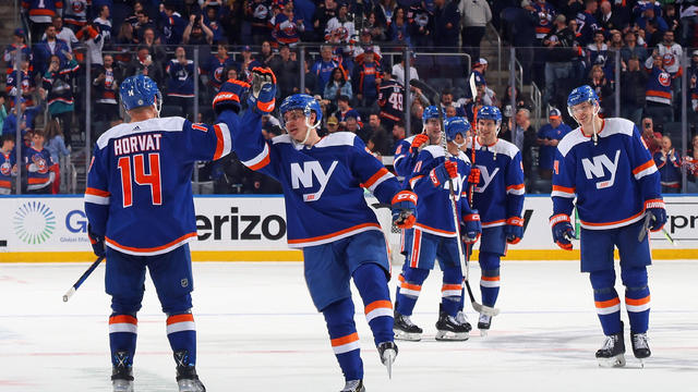 Bo Horvat #14 and Sebastian Aho #25 of the New York Islanders celebrate a 6-1 victory over the Tampa Bay Lightning at the UBS Arena on April 06, 2023 in Elmont, New York. 