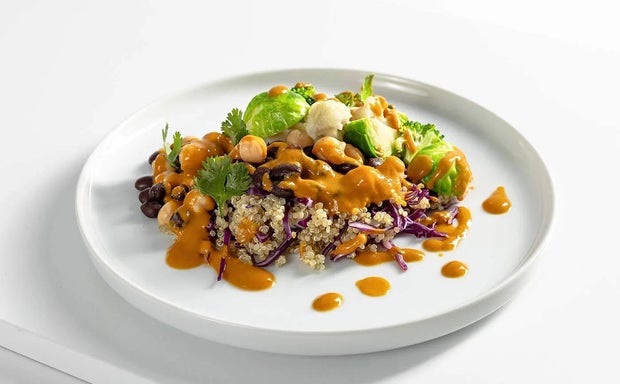 Plated quinoa with spicy sauce and black beans
