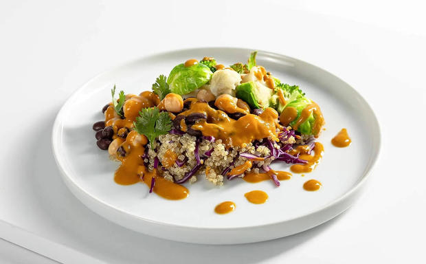 Plated quinoa with spicy sauce and black beans 