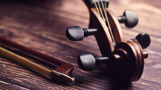 Antique violin on an old wooden floor 