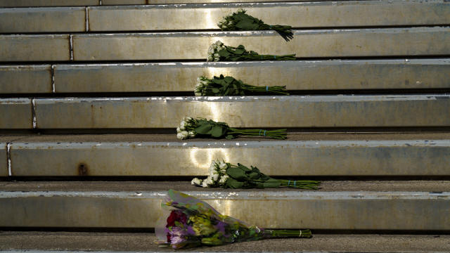 Bouquets of flowers lay at the entrance of Old National Bank on April 11, 2023, for the victims of the mass shooting in Louisville, Kentucky, a day earlier. 