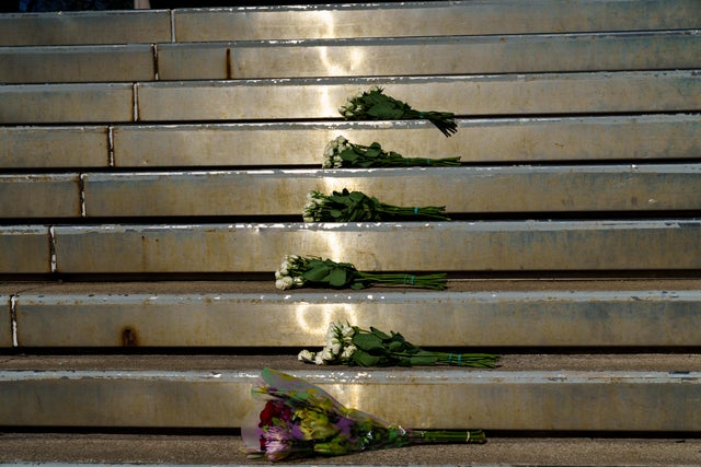Bouquets of flowers lay at the entrance of Old National Bank on April 11, 2023, for the victims of the mass shooting in Louisville, Kentucky, a day earlier. 