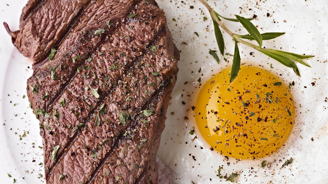 Steak and sunny side up egg with seasoning 