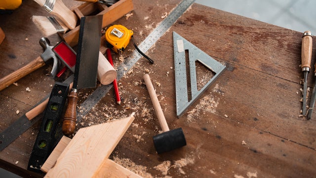 carpenter tools,hammer,meter,nails,shavings, and chisel over wood table 
