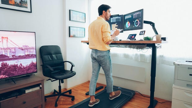 man using desk treadmill 