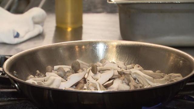 Mushrooms in a pan on a stove. 