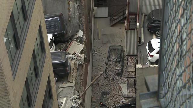 An overhead view of a partially collapsed parking garage. 