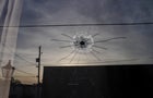 A bullet hole is seen at the entrance of Mahogany Masterpiece Dance Studio the day after a shooting at a teenager's birthday party in Dadeville, Alabama, April 16, 2023. 