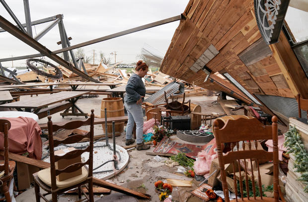 Kimber Hendrickson, owner of the Scissortail Silos event center, surveys debris of her venue that was destroyed during overnight tornadoes in Cole, Oklahoma, April 20, 2023. 