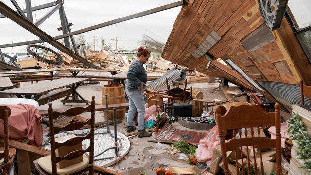 Kimber Hendrickson, owner of the Scissortail Silos event center, surveys debris of her venue that was destroyed during overnight tornadoes in Cole, Oklahoma, April 20, 2023. 