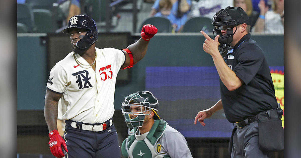 Adolis Garcia of the Texas Rangers reacts while at bat during the