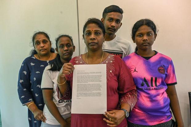 Leelavathy Suppiah (center), sister of a convicted drug trafficker Tangaraju Suppiah, who is scheduled for execution, poses with family members as she holds a petition letter to seek clemency in Singapore on April 23, 2023. 