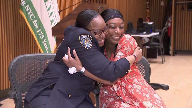 NYPD Officer Vadrien Alston and Sophia Jackson hug each other. 