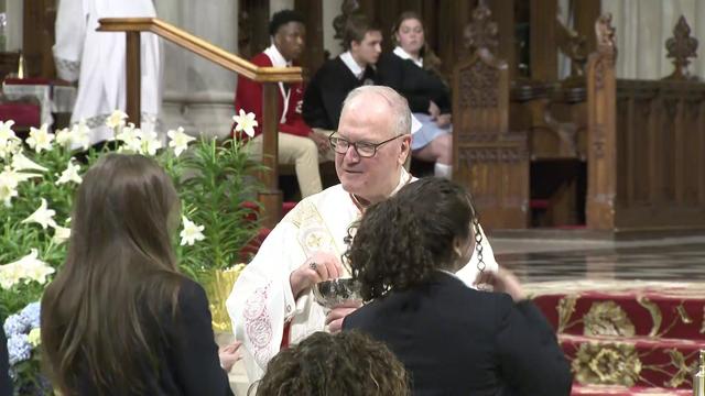 Timothy Cardinal Dolan speaks to teenagers at a mass celebrating graduating Catholic high school seniors. 