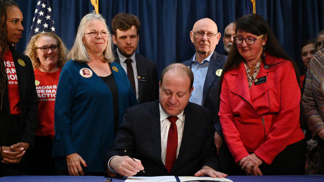 Gov. Jared Polis signed four gun control bills by Sandy and Lonnie Phillips, parents of Aurora theater shooting victim Jessica Ghawi, at the governor's office in Colorado State Capitol Building in Denver, Colorado on Friday, April 28, 2023. 