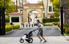 Man jogging with stroller past Paramount Pictures entrance 