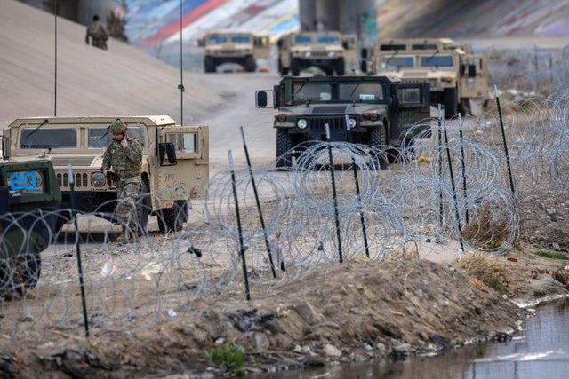 Texas National Guard soldiers stand guard at the U.S.-Mexico border on Jan. 7, 2023, as viewed from Ciudad Ju&aacute;rez, Mexico. 