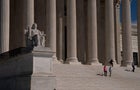 Visitors walk down the steps of the Supreme Court in Washington, D.C., on March 22, 2023. 
