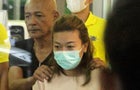 Sararat Rangsiwuthaporn, a suspect in over a dozen murders, is escorted by police officers at a police station in Bangkok, Thailand, April 26, 2023. 