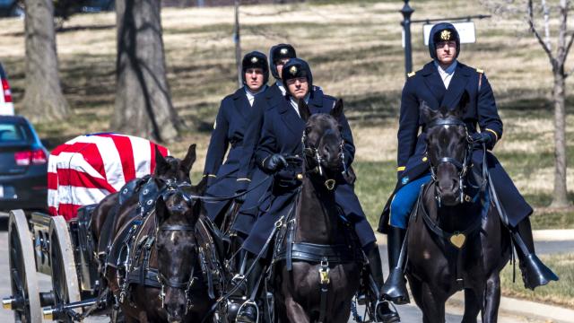 Burial at Arlington National Cemetery, Virginia, with coffin carried on horse drawn caisson 
