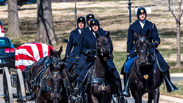 Burial at Arlington National Cemetery, Virginia, with coffin carried on horse drawn caisson 