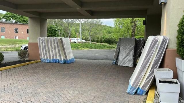 About a dozen mattresses sit outside a hotel in Orangeburg. 