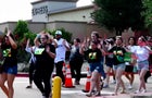 Shoppers leave with their hands up after police responded to a gunman who shot and killed eight people and wounded at least seven others at Allen Premium Outlets mall north of Dallas, in Allen, Texas, U.S. May 6, 2023. 