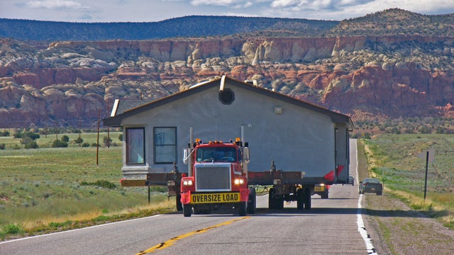 Wide-Load Truck Moving a House 