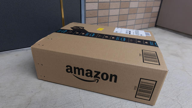 Amazon delivery package seen in front of a door 