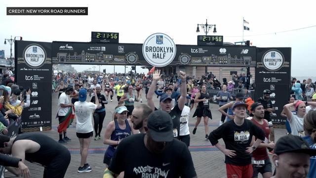 Runners cross the finish line on the Coney Island boardwalk during the Brooklyn Half marathon. 