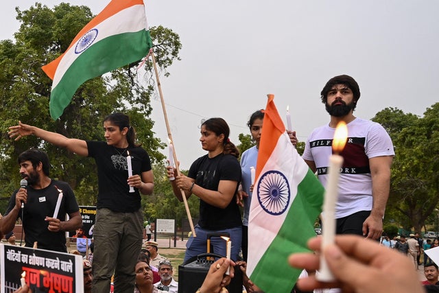 Indian wrestlers take part in a candlelight vigil to protest against the sport's local federation chief over allegations of sexual harassment and intimidation, in New Delhi on May 23, 2023.