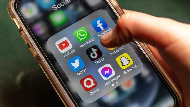Social media apps including Facebook, Snapchat and TikTok, are seen on a cellphone screen. 