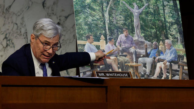 Senate Judiciary Committee member Sen. Sheldon Whitehouse displays a copy of a painting featuring Supreme Court Associate Justice Clarence Thomas alongside other conservative leaders during a hearing on Supreme Court ethics reform in the Hart Senate Office Building on Capitol Hill on May 2, 2023, in Washington, D.C. 
