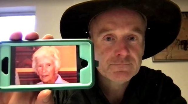 New South Wales, Australia businessman and community advocate Andrew Thaler holds up his phone showing a photo of Clare Nowland, May 19, 2023