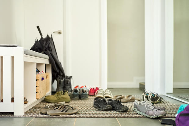Shoes scattered on door mat at home 