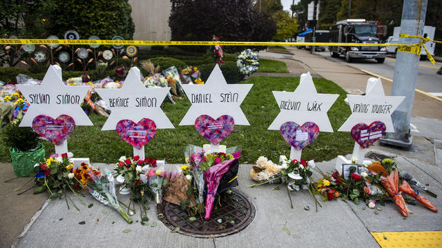 Flowers and stones are placed on the memorials erected outside the Tree of Life Synagogue in Pittsburgh's Squirrel Hill neighborhood, Oct. 29, 2018. 