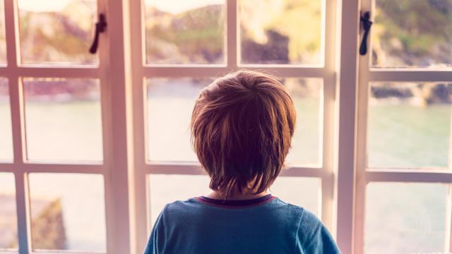 Boy looking out of window 