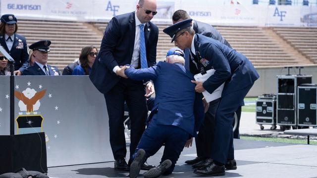 President Biden is helped up after falling during the graduation ceremony at the United States Air Force Academy, just north of Colorado Springs in El Paso County, Colorado, on June 1, 2023. 
