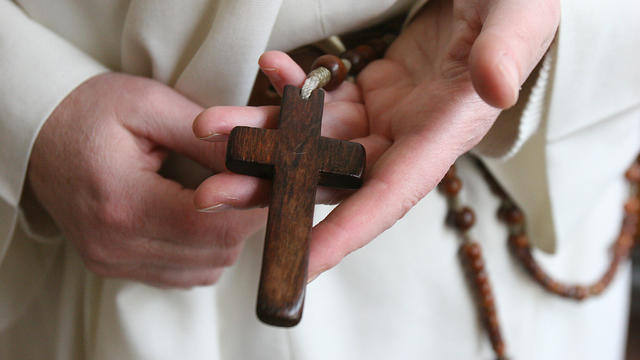 Nun Holding Cross 