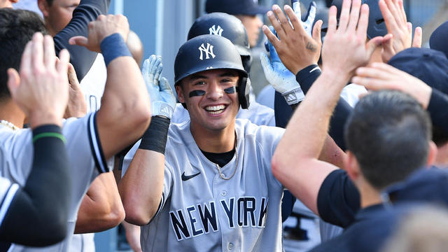 New York Yankees shortstop Anthony Volpe (11) gets high fives in the dugout after his home run during the MLB game between the New York Yankees and the Los Angeles Dodgers on June 4, 2023 at Dodger Stadium in Los Angeles, CA. 