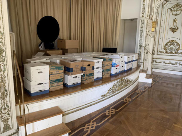 This image, contained in the indictment against former President Donald Trump, shows boxes of records being stored on the stage in the White and Gold Ballroom at Trump's Mar-a-Lago estate in Palm Beach, Florida. 