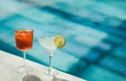 Two cold fresh summer cocktails on poolside close-up. Spritz and Margarita 