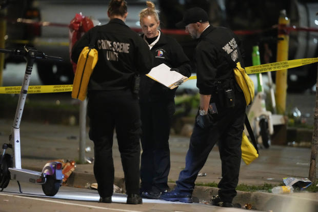 Denver Police Department investigators work the scene of a mass shooting early on June 13, 2023, in Denver. 