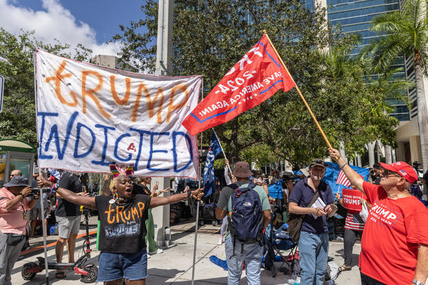 Opponents and supporters of former President Donald Trump demonstrate outside the courthouse in Miami 