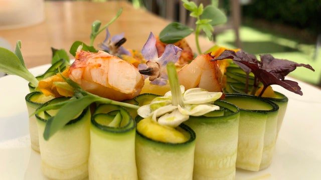 Fine dining, creative lobster dish served cucumber and flowers in michelin star restaurant 